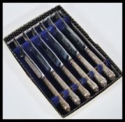 A set of vintage 20th Century six hallmarked silver handled dessert / butter knives complete in