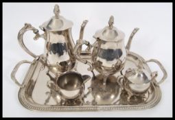 A vintage 20th Century four piece silver plated service in the Rococo style consisting of two