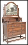 An early 20th Century oak dressing table chest having geometric moulding to the drawers with