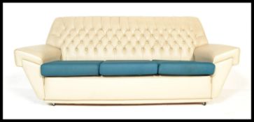 A vintage retro 20th Century sofa of Chesterfield type having button back upholstered in white