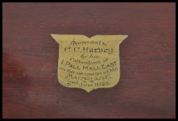 An early 20th Century mahogany cutlery canteen, the hinged lid opening to reveal a green baize lined