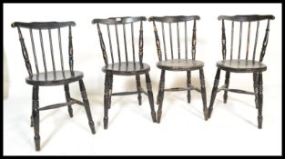 A set of four hoop back spindle dining chairs, solid pad seats raised on tapering supports united by