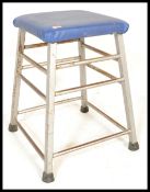 A vintage 20th Century school gymnasium vaulting horse of square form, raised on a metal tubular