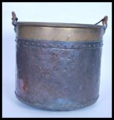 A 19th Century Victorian hand worked / beaten copper and brass bucket / pail, carry handle atop over