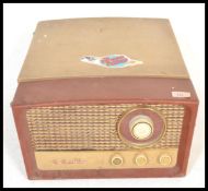A vintage 20th Century four speed two tone record player by HMV, fitted with a four speed Garrard