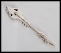 A silver hallmarked brooch in the form of an arrow with celtic style decoration. Hallmarked