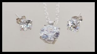 A stamped 925 silver necklace with a prong set cz pendant and a pair of matching silver and cz