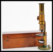 A 19th Century Victorian brass microscope on circular swivel base complete in original box with JD