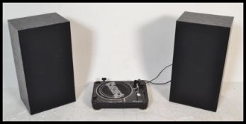 A vintage 20th Century Numark record turntable deck along with a pair of tall ebonised speakers.
