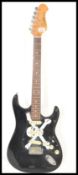 A 20th Century Encore Coaster six string electric guitar, black body with applied skull and