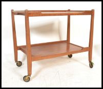 A vintage retro 20th Century teak wood two tier Danish trolley raised on angular supports