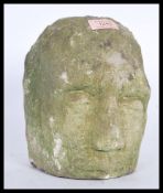 An unusual carved Bath stone sculpted bust garden ornament in the form of a head with closed eyes,