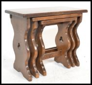A set of three vintage 20th Century graduating oak nest of tables by Jaycee, the graduating nest