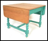 A 1930's painted shabby chic oak barley twist drop leaf dining table. Raised on barley twist legs