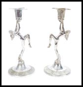 A pair of vintage retro 20th Century Art Deco style chrome candlesticks raised on stepped circular