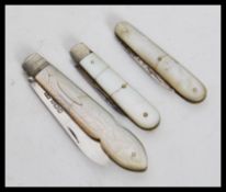 A group of three hallmarked silver fruit pen knives having mother of pearl handles. Total weight