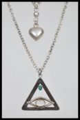 Two silver necklaces to include a pendant necklace with a triangular pendant with an eye design