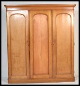 A Victorian oak / ash triple wardrobe linen press compactum. Raised on a plinth base with double