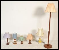 A collection of retro 20th Century teak wood desk lamps of differing designs together with a teak