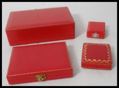A collection of four vintage 20th Century red leather Cartier jewellery boxes of varying sizes.