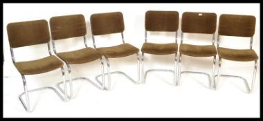 A set of six cantilever dining chairs, raised on chrome frames with brown velour upholstered seat