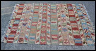 A vintage 20th Century Kilim floor rug / carpet having hand woven multi coloured striped geometric