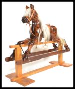 A large vintage 20th Century hand carved carousel type rocking horse raised on wooden rocker base