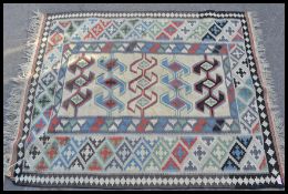 A vintage 20th Century kilim geometric having a grey ground with a black geometric border and blue