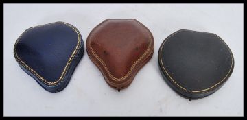 A group of three vintage leather bracelet jewellery boxes of teardrop / pear form, clasps fitted