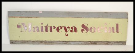 A 20th Century restaurant advertising sign for Maitreya Social, hand painted in bold lettering on