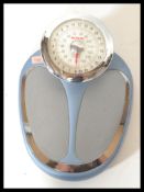 A set of vintage 20th Century doctors style weighing scales by EKS, finished in a blue enamel with