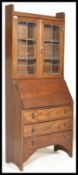 A late 19th Century Victorian Arts & Crafts Liberty style oak student bureau having bookcase cabinet