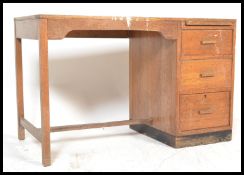 A retro 20th Century Air Ministry style oak single pedestal desk having a straight pedestal of three