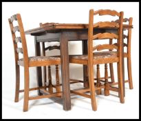 A vintage mid 20th Century Ercol 1940's stained beech draw leaf table along with a set of four