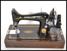 A mid 20th Century vintage cased electric Singer sewing machine. The machine painted in typical
