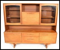 A 1970's Portwood Danish influence highboard sideboard . Raised on tapering legs with a series of