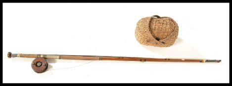 A vintage 20th Century split cane fly fishing rod, together with a vintage wooden and brass fly reel