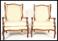 A pair of 20th Century Contemporary French style armchairs. The chairs having mahogany show wood