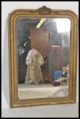A 19th Century Victorian French gilt mirror having a wooden and gesso moulded frame, with an applied