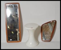 A retro 20th Century Tam Tam stool in white together with two retro framless teak wood atomic wall