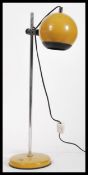 A vintage retro 20th Century Eyeball desk lamp raised on circular base with adjustable tubular