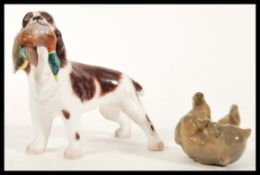 A Royal Copenhagen ceramic figurine of a bear cub ( 1124 ) on it's back with his feet in the air