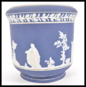 A 19th Century Adams jasperware jardiniere planter, having raised white classical scenes and borders