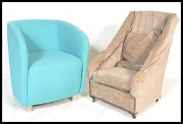 A Victorian 19th century nursing chair being raised on mahogany turned legs and loose covers