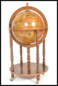 An antique style floor standing cocktail drinks cabinet in the form of a terrestrial globe with