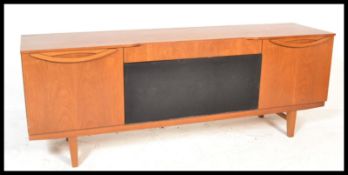 A retro teak wood sideboard credenza having a central fall front cupboard flanked by further