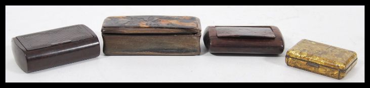 A group of four snuff boxes to include a horn and tortoiseshell box with butterfly decoration,