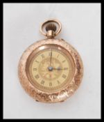 An early 20th Century 9ct gold cased pocket watch having floral engraving to the case, a gilt face