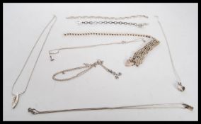 A collection of vintage silver jewellery to include a hallmarked heart lock bracelet, three