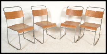 A set of four vintage / retro stacking chapel chairs, the chairs with ply seats and back rests
